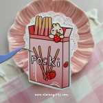 Strawberry Pocky box vinyl sticker featuring strawberries and a cute Elaine Girls character holding a strawberry