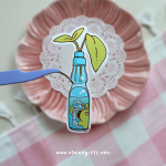 Ramune Plant vinyl sticker featuring a blue Japanese ramune soda bottle with green plant leaves growing from the top by Elaine Girls