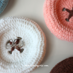 Crochet button coasters in cream, pink, and brown with bow details by Elaine Girls