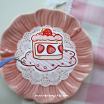 Strawberry Cake vinyl sticker featuring a slice of strawberry cake with pink frosting, fresh strawberries, and a strawberry on top by Elaine Girls